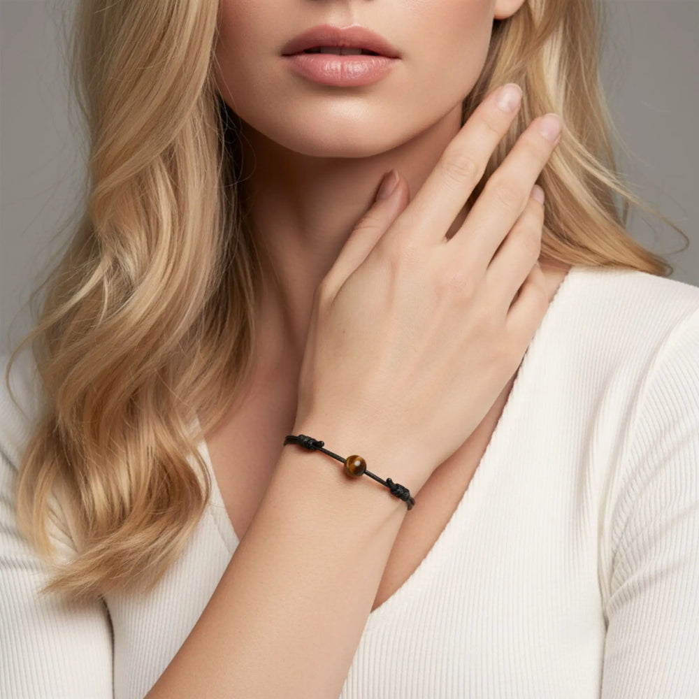 Tiger’s eye bead bracelet on adjustable waxed nylon cord worn on woman’s wrist