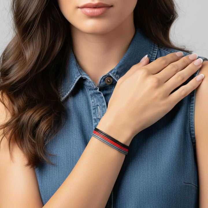 Woman wearing a denim shirt with a close-up of her arm showing a bracelet.