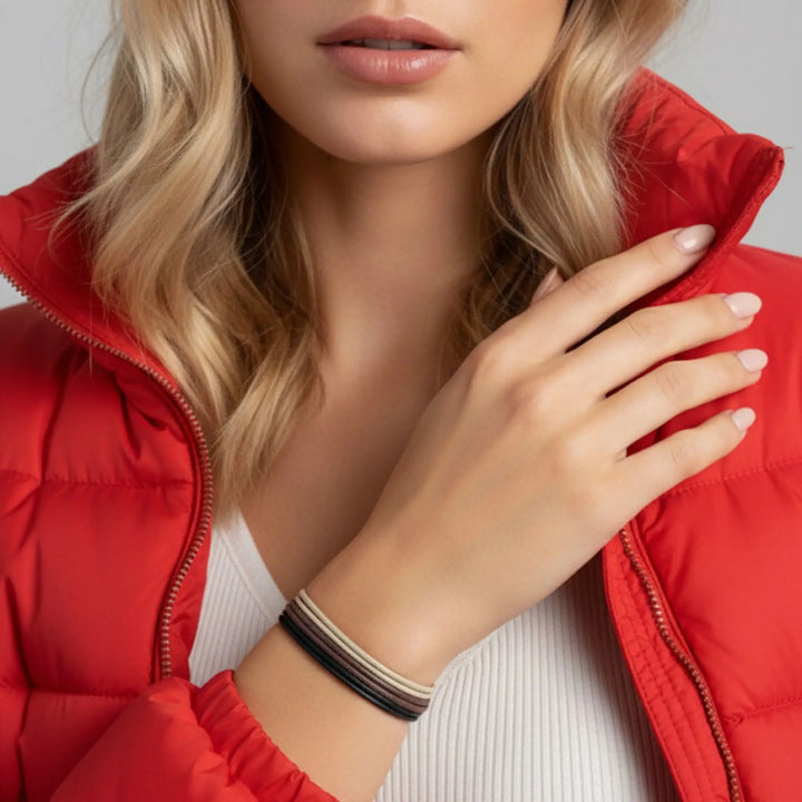 Person wearing a red puffer vest with a neutral background