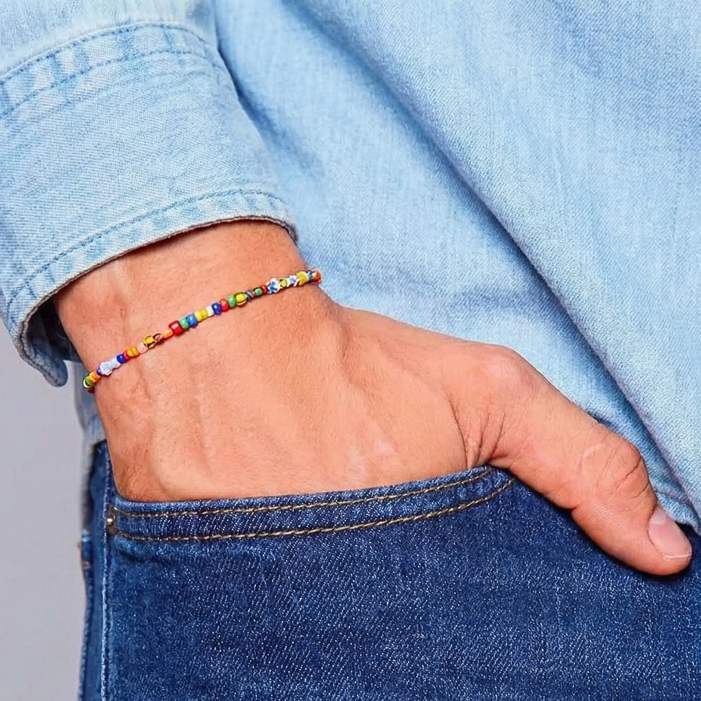 Colorful beaded bracelet on a wrist with a blue denim background
