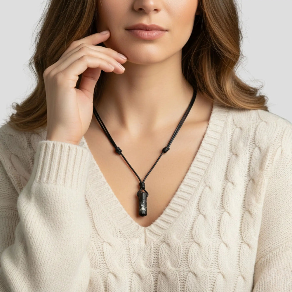 Woman wearing a tourmaline necklace with a neutral background