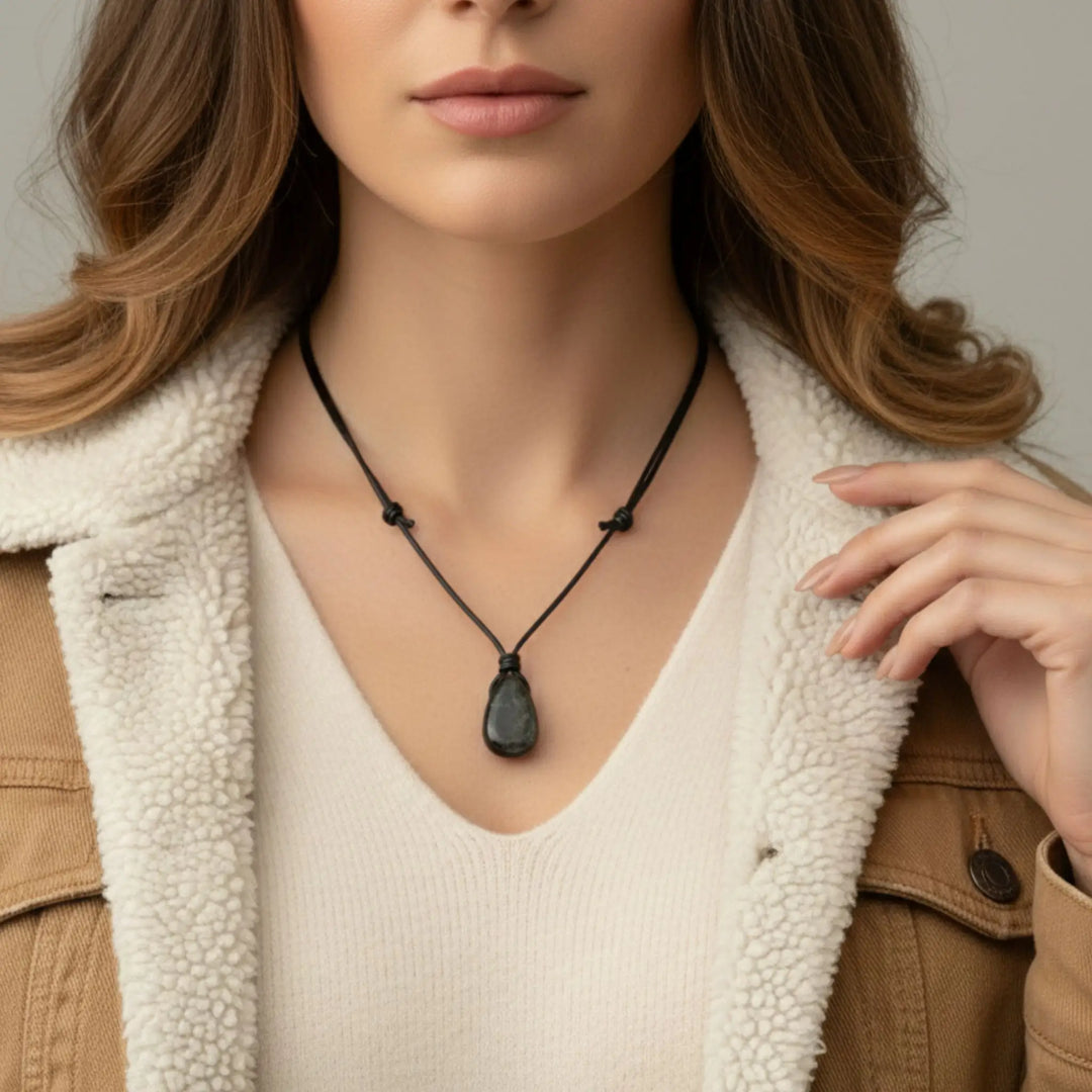 Woman wearing a black shungite  necklace with a neutral background