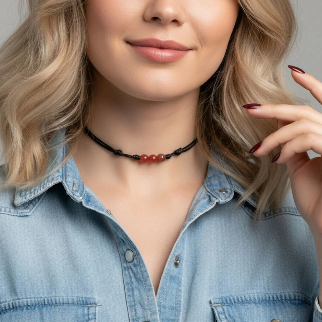 Woman wearing a carnelian choker necklace with a neutral background