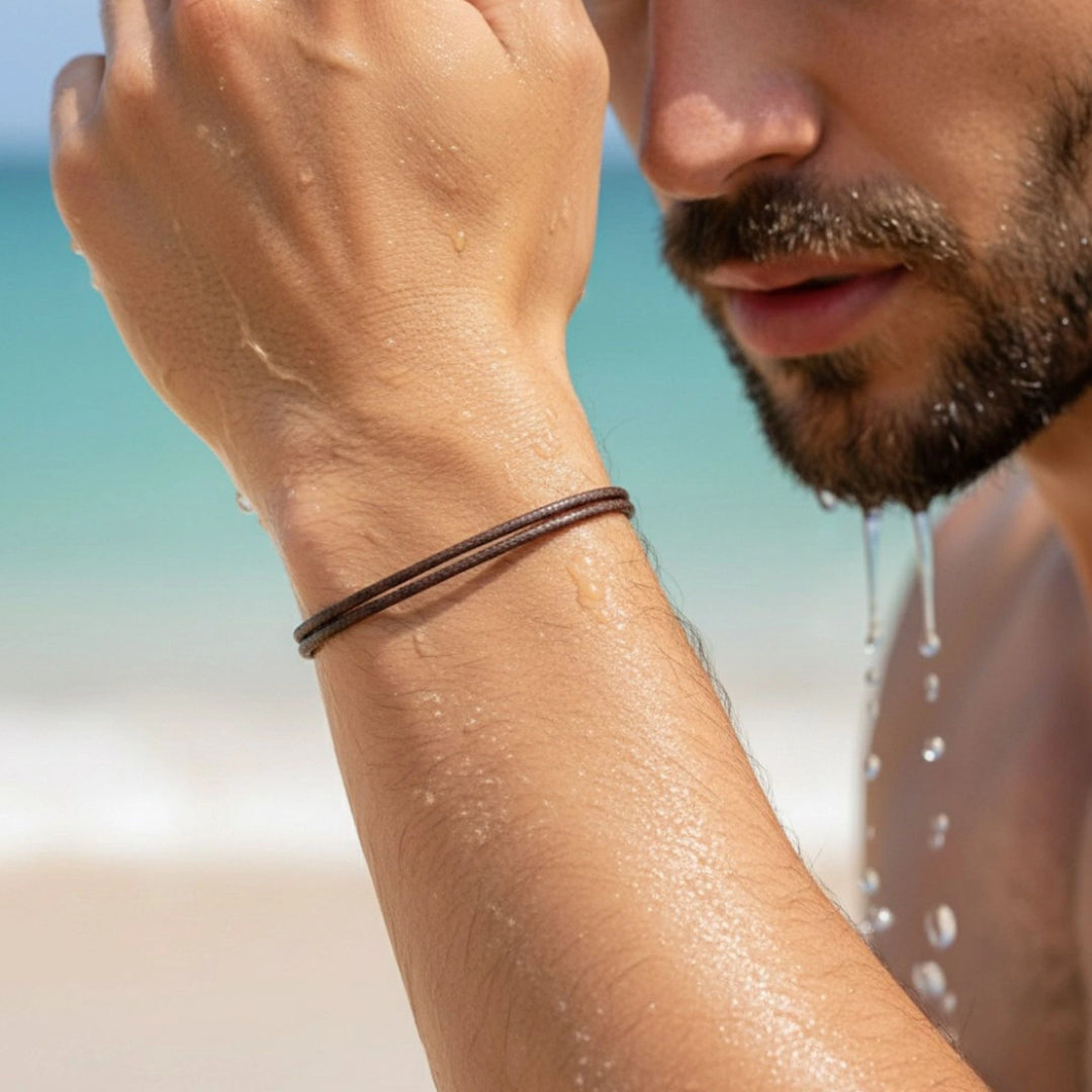Man with a beard and faux leather bracelet on a beach