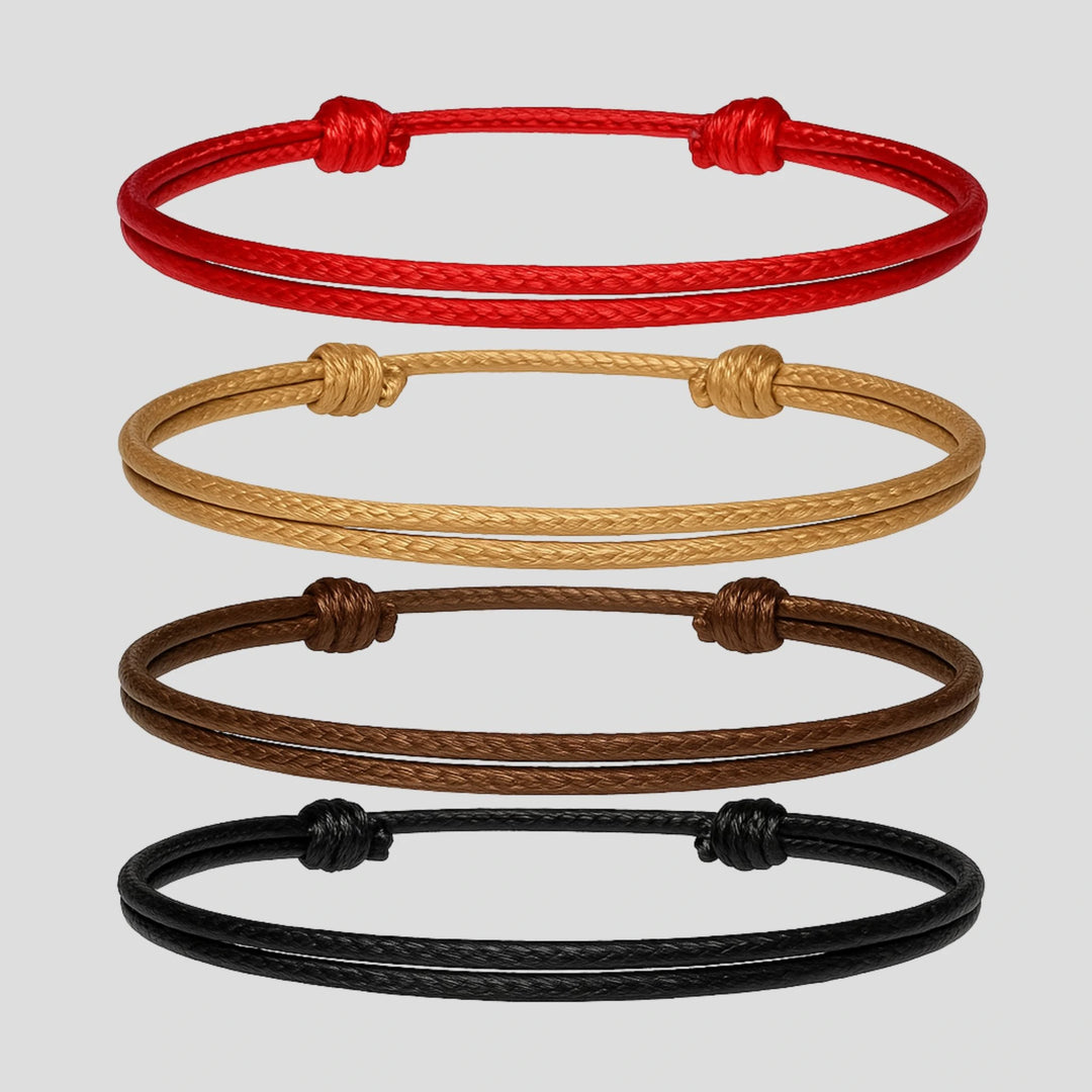 Four braided bracelets in red, beige, brown, and black on a light gray background