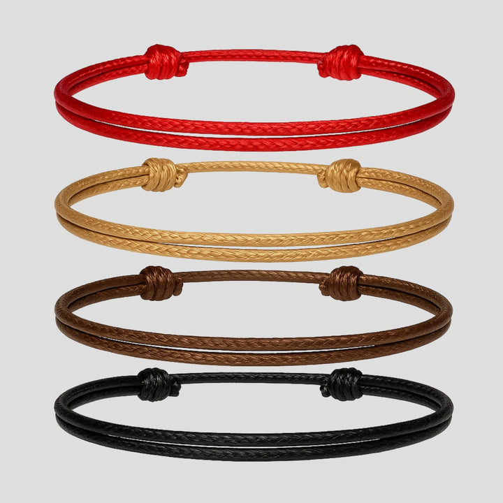 Four braided bracelets in red, beige, brown, and black on a light gray background