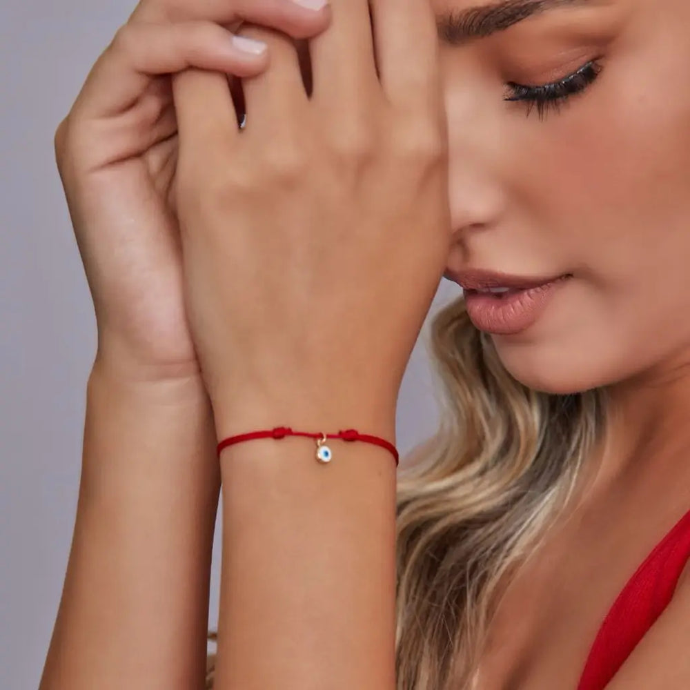 Woman wearing 14K Gold Vermeil Evil Eye Bracelet – Red String