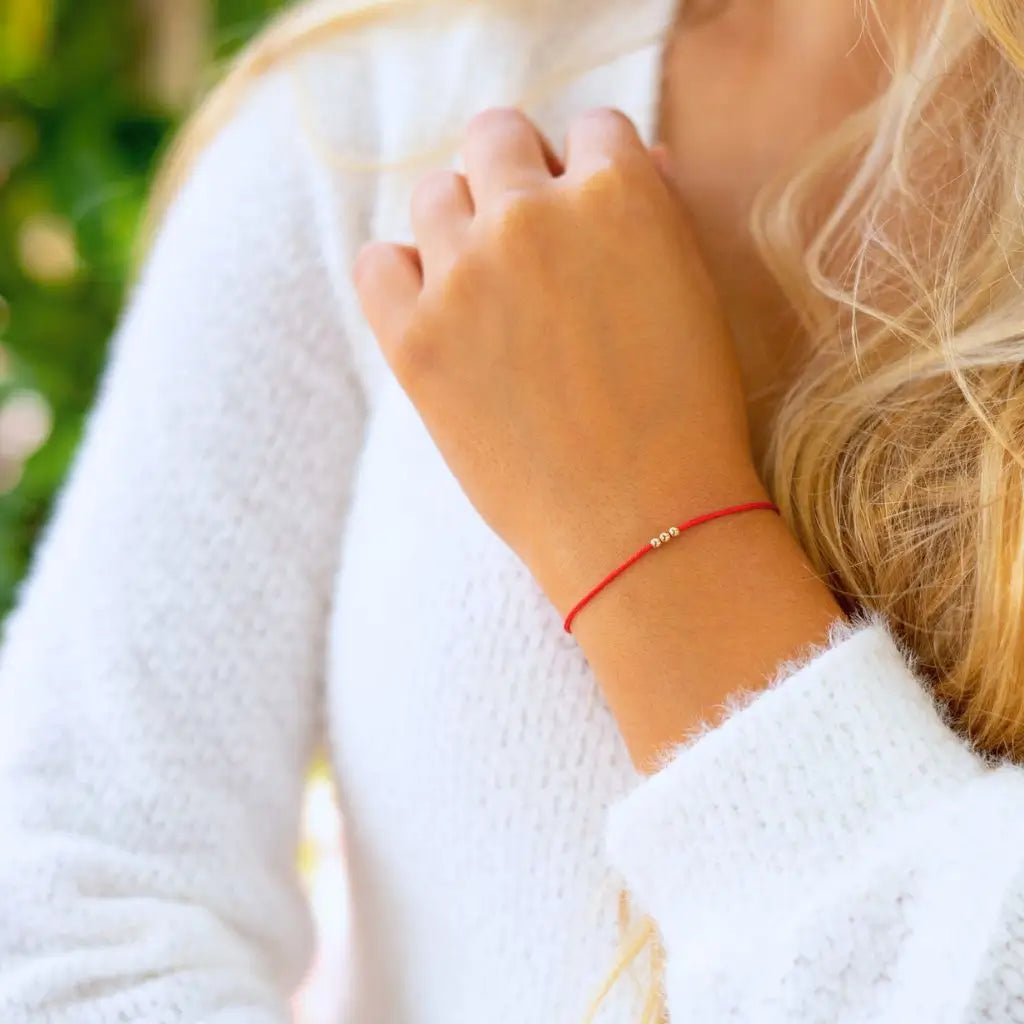 Woman Wearing 14K Solid Gold Red String Bracelet Handmade by Luck Strings

